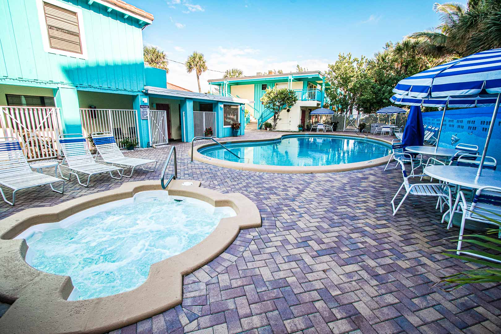 A colorful outdoor swimming pool and jacuzzi at VRI's Sand Dune Shores in Florida.